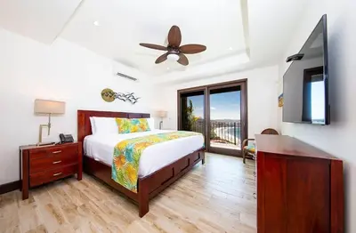 a bedroom with a bed and a ceiling fan at 360 Splendor 207A-Ocean View 2 Br Condo-Breakfast Included! in Playa Flamingo