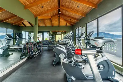 a gym with treadmills and a row of bikes at 360 Splendor 207A-Ocean View 2 Br Condo-Breakfast Included! in Playa Flamingo