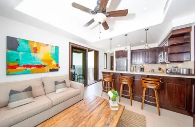 a living room with a couch and a kitchen at 360 Splendor 105B Ocean View Condo- With Breakfast in Playa Flamingo