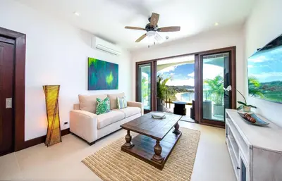 a living room with a couch and a table at 360 Splendor 202-Ocean View Condo-Breakfast Included! in Playa Flamingo