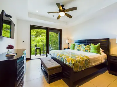 a bedroom with a bed and a ceiling fan at 360 Splendor 302-Ocean View Condo-Breakfast in Playa Flamingo