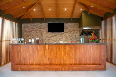 a bar with a flat screen tv above it at 360 Splendor 302-Ocean View Condo-Breakfast in Playa Flamingo