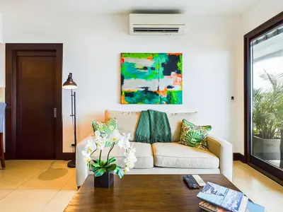 a living room with a couch and a table at 360 Splendor 302-Ocean View Condo-Breakfast in Playa Flamingo