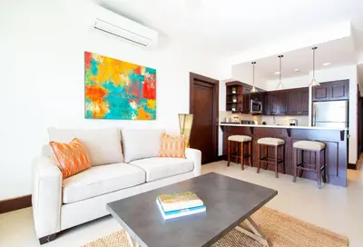 a living room with a white couch and a table at 360 Splendor 303-Ocean View Condo-Breakfast Included! in Playa Flamingo