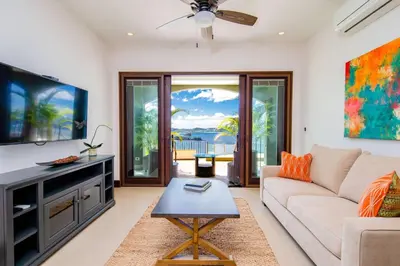 a living room with a couch and a tv at 360 Splendor 305 Ocean View Condo- With Breakfast in Playa Flamingo