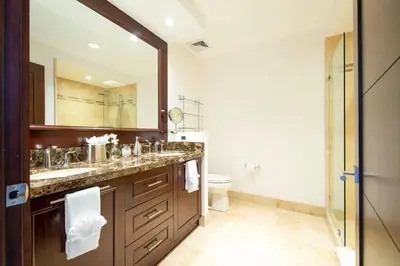 a bathroom with a sink and a mirror and a toilet at 360 Splendor 304 Ocean View Condo- With Breakfast in Playa Flamingo