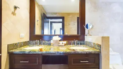 a bathroom with two sinks and a large mirror at 360 Splendor 207F-Ocean View Residence-Breakfast in Playa Flamingo