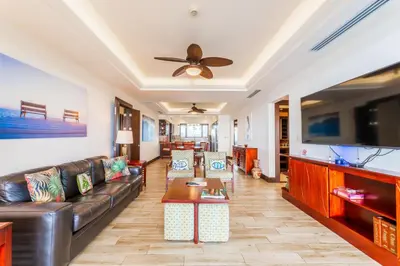 a living room with a couch and a flat screen tv at 360 Splendor 207F-Ocean View Residence-Breakfast in Playa Flamingo
