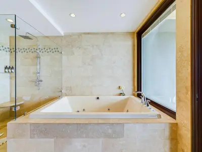 a large bath tub in a bathroom with a shower at 360 Splendor 310 Ocean View 3Br Breakfast in Playa Flamingo