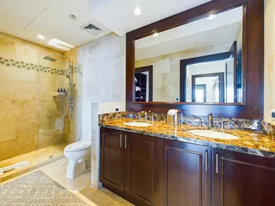 a bathroom with two sinks and a shower at 360 Splendor 310 Ocean View 3Br Breakfast in Playa Flamingo