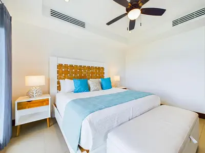 a bedroom with two beds and a ceiling fan at 360 Splendor 310 Ocean View 3Br Breakfast in Playa Flamingo