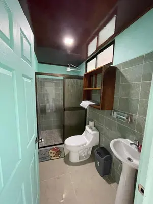 a bathroom with a toilet and a sink at Encanto Arenal lodge in Fortuna