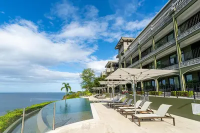 a hotel with a swimming pool next to the ocean at 360 Splendor 308A-Ocean View 2 Br -Breakfast Included! in Playa Flamingo
