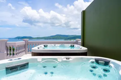 a hot tub on a balcony with a view of the ocean at 360 Splendor 405 Ocean View Condo- With Breakfast in Playa Flamingo