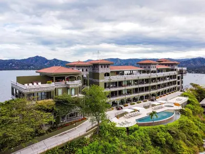 a large hotel on the water with a pool at 360 Splendor 405 Ocean View Condo- With Breakfast in Playa Flamingo