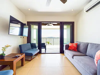 a living room with a couch and a table at 360 Splendor 307B-Ocean View Condo-Breakfast in Playa Flamingo