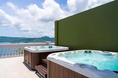 a jacuzzi tub on a balcony with a view at 360 Splendor 308B Ocean View Condo- With Breakfast in Playa Flamingo