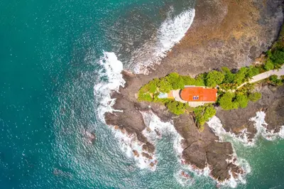 an aerial view of a house on a island in the ocean at 360 Splendor 308B Ocean View Condo- With Breakfast in Playa Flamingo