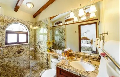 a bathroom with a sink and a shower and a mirror at Palms 14 Luxury Beachfront Villa in Playa Flamingo