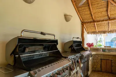 a kitchen with a stove top oven in a kitchen at Palms 14 Luxury Beachfront Villa in Playa Flamingo