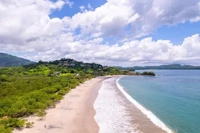 a view of the beach on a tropical island at Palms 14 Luxury Beachfront Villa in Playa Flamingo
