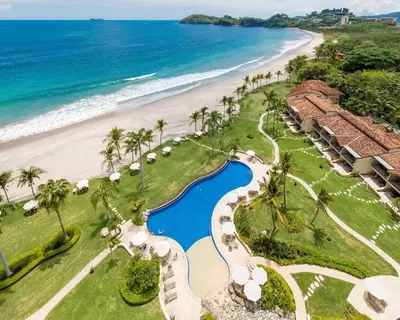an aerial view of a resort and the beach at Palms 14 Luxury Beachfront Villa in Playa Flamingo