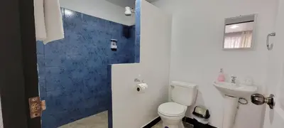 a bathroom with a toilet and a sink at Panda House in Quepos