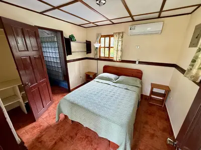 a small bedroom with a bed in a room at Brisa Del Mar in Playa Hermosa