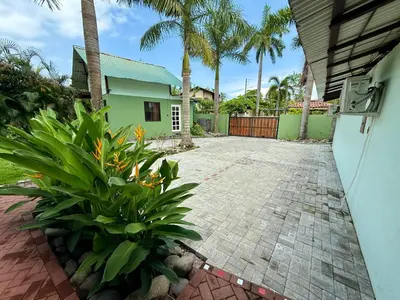 a driveway leading to a house with palm trees at Brisa Del Mar in Playa Hermosa
