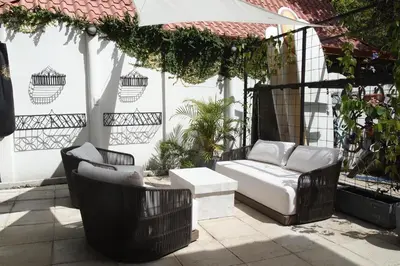a porch with two chairs and a couch on a patio at Casa Vitality Bed and Breakfast - Playa Guiones, Nosara - 4 Minute Walk to the Beach in Nosara