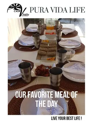 a table with plates of food on top of it at Casa Vitality Bed and Breakfast - Playa Guiones, Nosara - 4 Minute Walk to the Beach in Nosara
