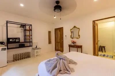 a bedroom with a bed and a mirror at Casa Vitality Bed and Breakfast - Playa Guiones, Nosara - 4 Minute Walk to the Beach in Nosara