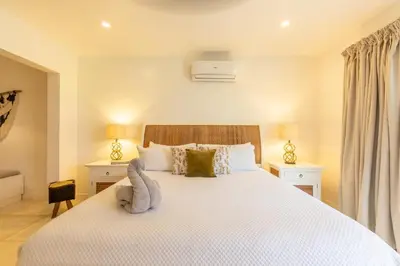 a bedroom with a bed with a stuffed animal on it at Casa Vitality Bed and Breakfast - Playa Guiones, Nosara - 4 Minute Walk to the Beach in Nosara