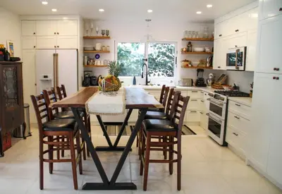 a kitchen with a wooden table and chairs at Casa Vitality Bed and Breakfast - Playa Guiones, Nosara - 4 Minute Walk to the Beach in Nosara