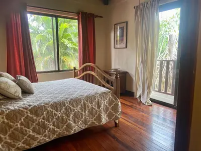 a bedroom with a bed and a large window at Casa de veraneo Quinta Las Trillizas in Esparza