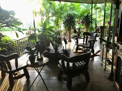 a patio with chairs and plants on a balcony at Casa de veraneo Quinta Las Trillizas in Esparza