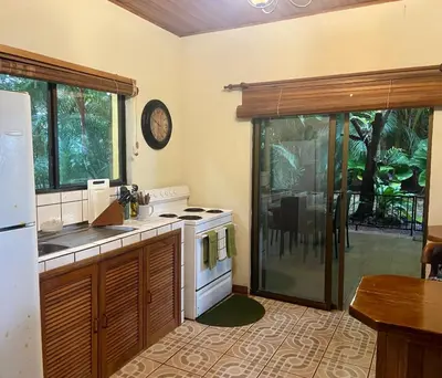 a kitchen with a sink and a stove top oven at Casa de veraneo Quinta Las Trillizas in Esparza