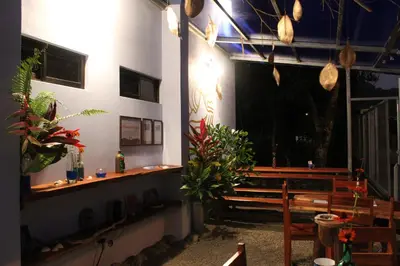 a church with benches and potted plants in a room at Habitación a 26 kilómetros de Jaco, Tulin Azul in Jacó
