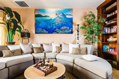 a living room with a couch and a painting on the wall at El Diria 302- 2 Bedroom Ocean View Condo in Tamarindo