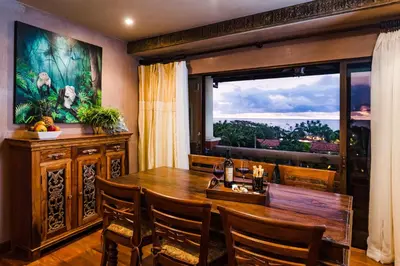 a dining room with a table and a large window at El Diria 302- 2 Bedroom Ocean View Condo in Tamarindo