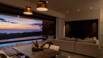 a living room with a couch and a table at Casa Olala Santa Teresa in Santa Teresa Beach