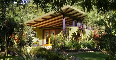 a small house with a garden in front of it at Chirripo Art Hotel in Chimirol
