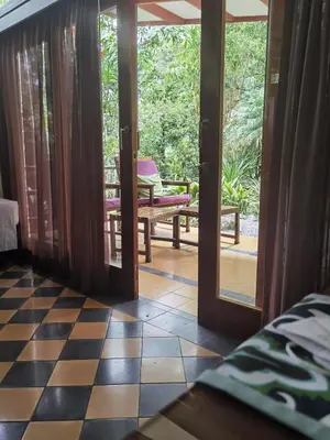 a room with a door open to a patio at Chirripo Art Hotel in Chimirol