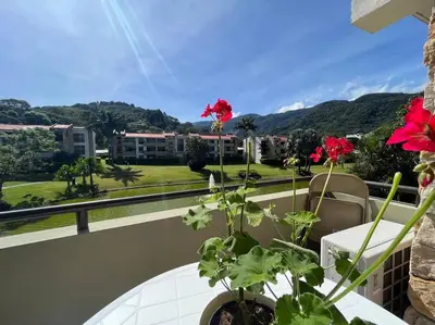 a balcony with a table with flowers on it at CR MARIPOSA RENTALS Lakeview PENTHOUSE with office space, pool, gym, tennis in Santa Ana
