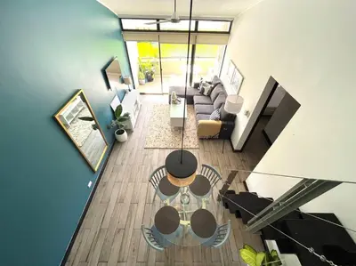 an overhead view of a living room with a couch at CR MARIPOSA RENTALS Lakeview PENTHOUSE with office space, pool, gym, tennis in Santa Ana