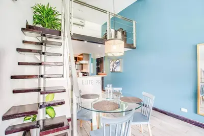 a dining room with a glass table and chairs at CR MARIPOSA RENTALS Lakeview PENTHOUSE with office space, pool, gym, tennis in Santa Ana