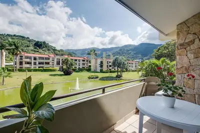 a balcony with a table and a view of a building at CR MARIPOSA RENTALS Lakeview PENTHOUSE with office space, pool, gym, tennis in Santa Ana