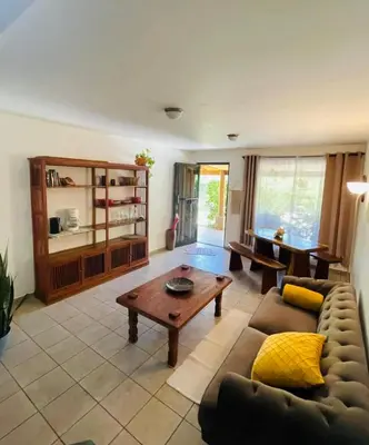 a living room with a couch and a coffee table at Cozy and Peaceful Beach Apartment in Playa Grande