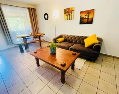 a living room with a couch and a coffee table at Cozy and Peaceful Beach Apartment in Playa Grande