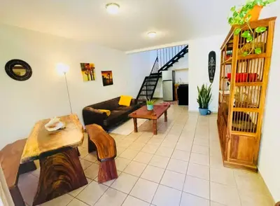 a living room with a couch and a table at Cozy and Peaceful Beach Apartment in Playa Grande